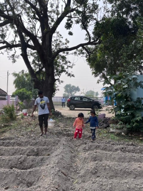 Children walking through agricultural fields in Village Gauri near Kala Namak rice farms