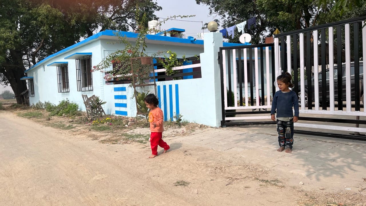 Children outside a village home at Kala Namak Healing Farms in Siddharthnagar